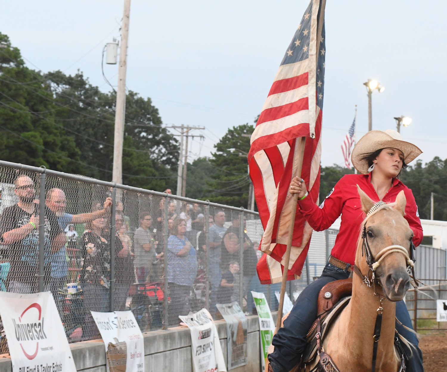 Makayah Alexander, a barrel racer from Lebanon, Mo., circles the Memorial Park arena Friday evening during a patriotic opening ceremony for the Double B Rough Stock Association’s rodeo hosted by the Owensville Fire Department.  She won the Saturday competition of the of the open barrels event during the rodeo’s two-night  production in Owensville.