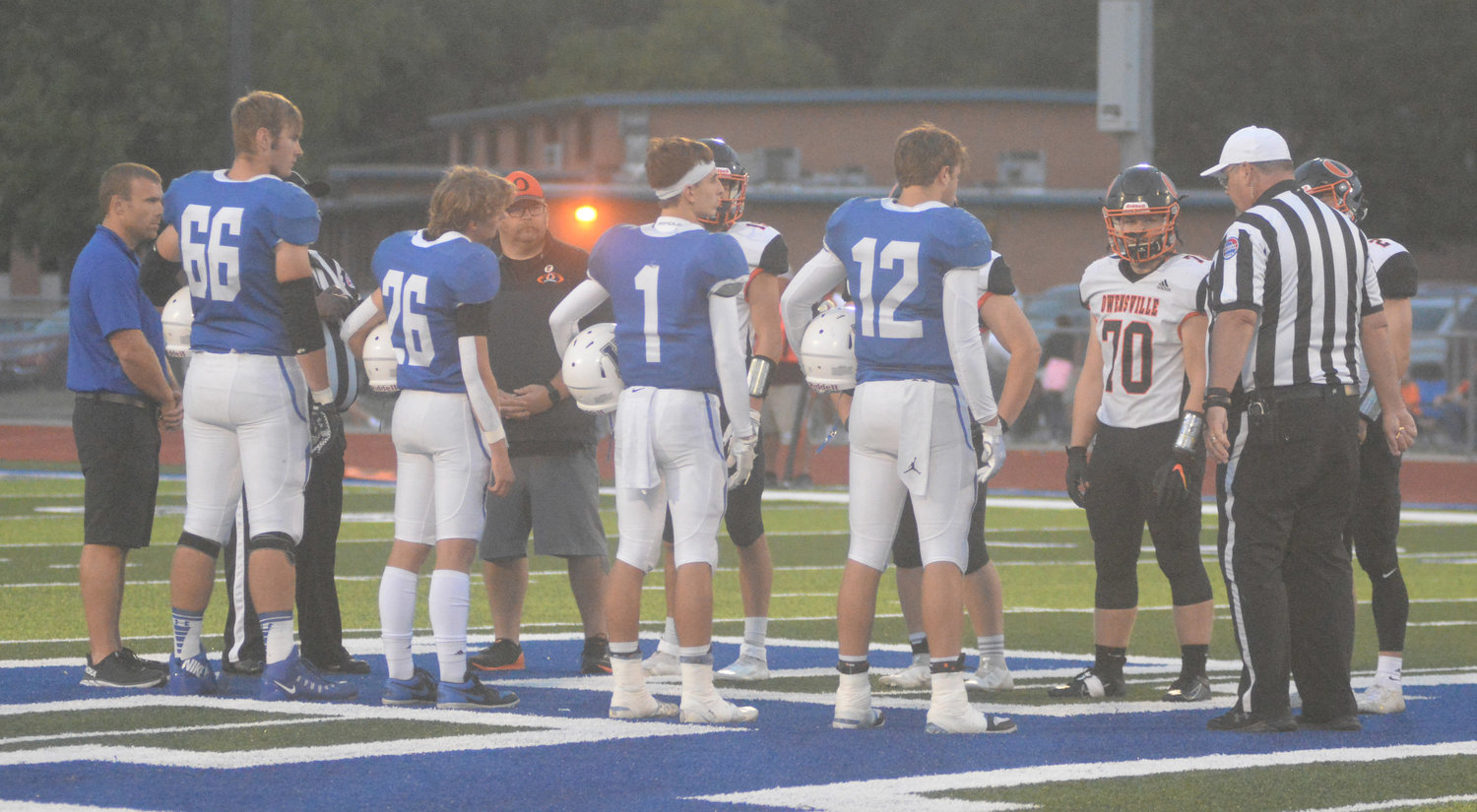 Captains (above) met for the pregame coin toss at Bearcat Memorial Stadium before kickoff of the annual Gasconade County Bowl between the host Hermann Bearcats and visiting Owensville Dutchmen. Hermann captains coached by Andy Emmons (above, from left) include Schuler Erickson (66), Kole Eldringhoff (26), Conner Coffey (1) and Parker Anderson (12). Owensville captains coached by Nathan Cabot (above, from left) were Derek Brandt, Logan Evans, Brent Helmig and Brendan Decker.
