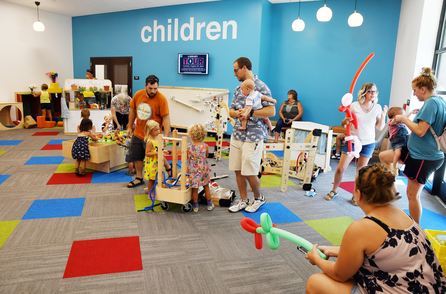 Parents and grandparents on Saturday visit the Scenic Regional Library Children’s section at the new Hermann branch following the dedication ceremony of the facility located in the Bavarian Hills Plaza off of Highway 19 at Route H.