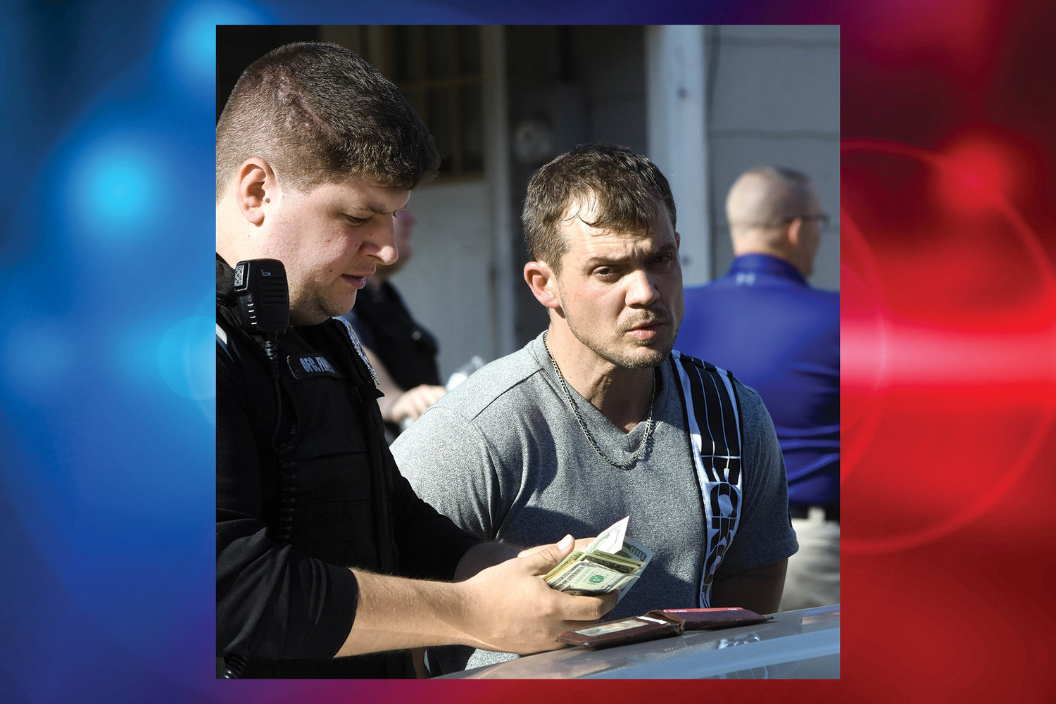 DANIEL N. HANKINS watches Jan. 11 as Owensville policeman Brenn Finley counts out the $935 in cash Hankins had on him after he surrendered at a residence on Marvin Avenue. Hankins was wanted on an absconder warrant from Probation and Parole.
