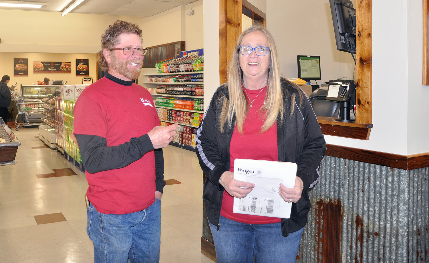 Co-owner Stan Voss (left) and Julie Mesger, price coordinator/office manager were all smiles as customers flooded the store. 